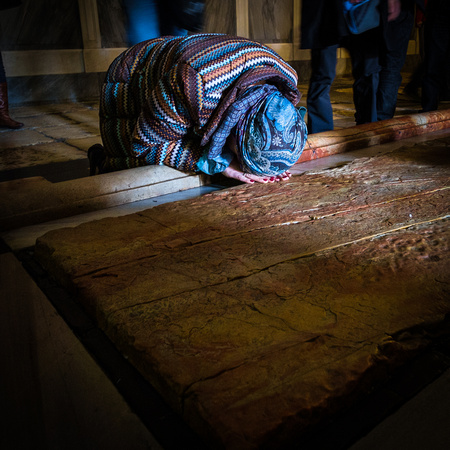Praying at the Stone of the Anointing at The Church of the Holy Sepulchre